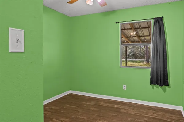 a view of a small space with window and hardwood