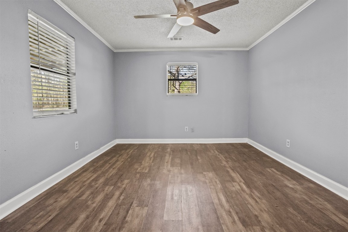 801 Campbell Acres Road Cleveland, TX 77328 - Photo 16 of 36 wooden floor in an empty room with a window
