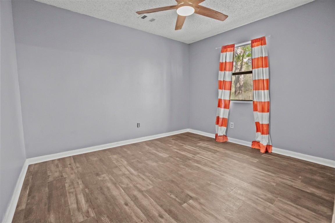 801 Campbell Acres Road Cleveland, TX 77328 - Photo 17 of 36 an empty room with wooden floor and entryway