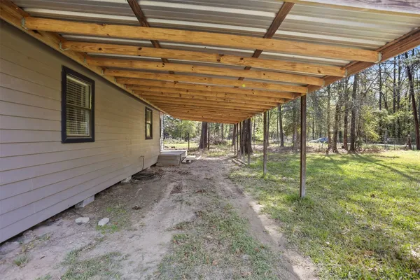 a view of a backyard with plants and a backyard