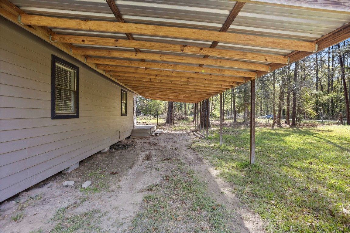 801 Campbell Acres Road Cleveland, TX 77328 - Photo 20 of 36 a view of a backyard with plants and a backyard