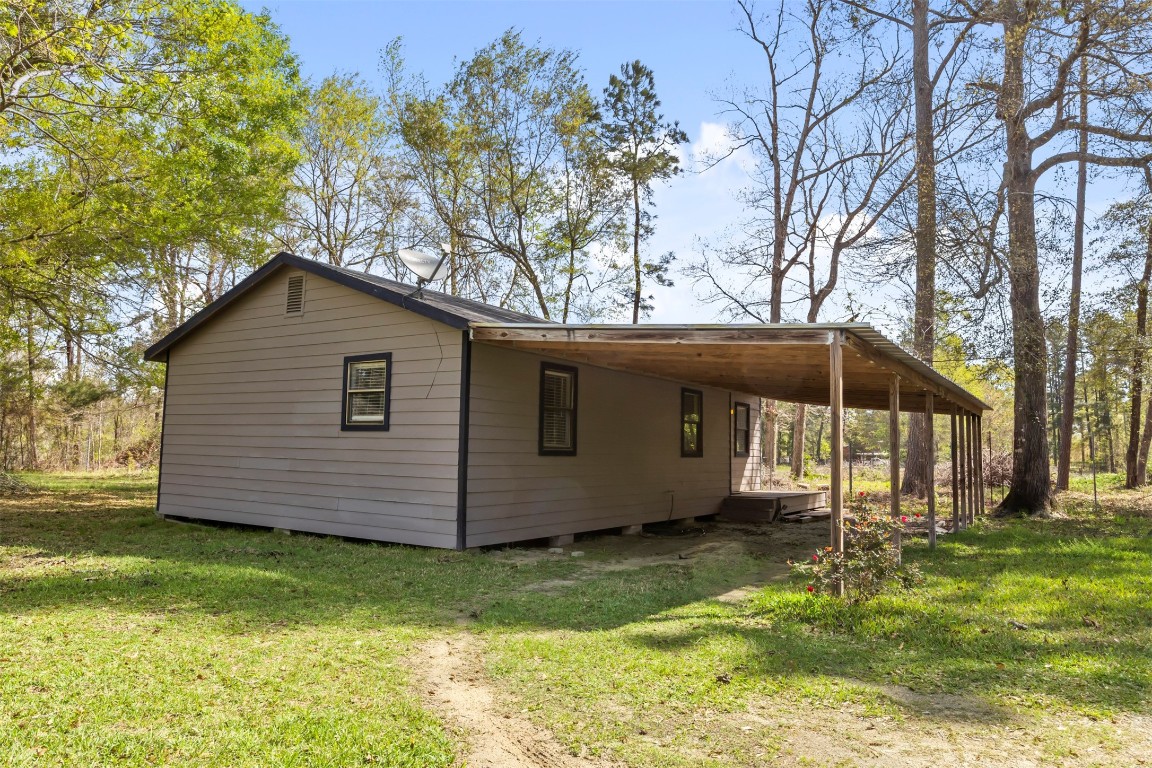 801 Campbell Acres Road Cleveland, TX 77328 - Photo 23 of 36 a view of a house with a yard