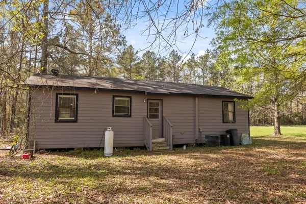 a backyard of a house with barbeque oven