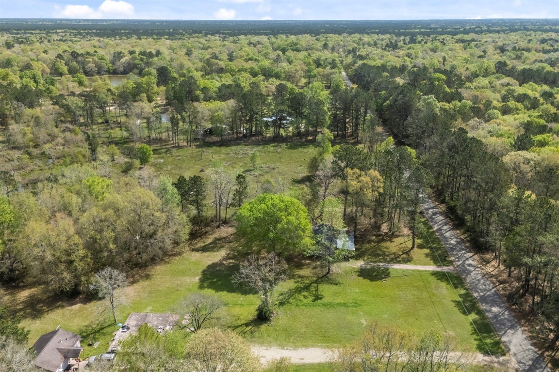 801 Campbell Acres Road Cleveland, TX 77328 - Photo 29 of 36 a view of a lake with a yard