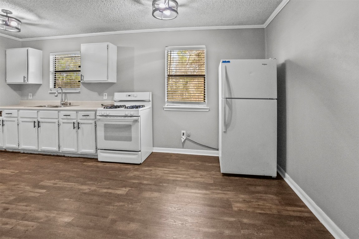801 Campbell Acres Road Cleveland, TX 77328 - Photo 6 of 36 a kitchen with a refrigerator sink stove and cabinets