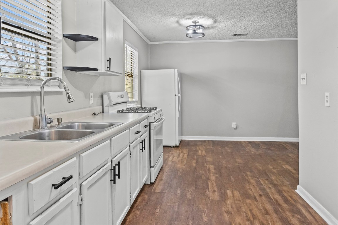 801 Campbell Acres Road Cleveland, TX 77328 - Photo 8 of 36 a kitchen with a sink stove and cabinets