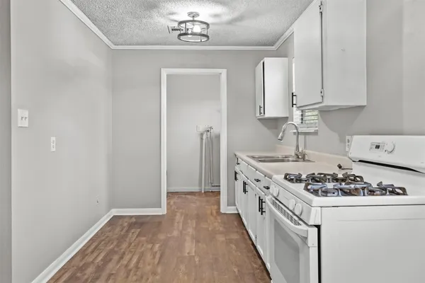 a kitchen with stainless steel appliances granite countertop a stove and a sink
