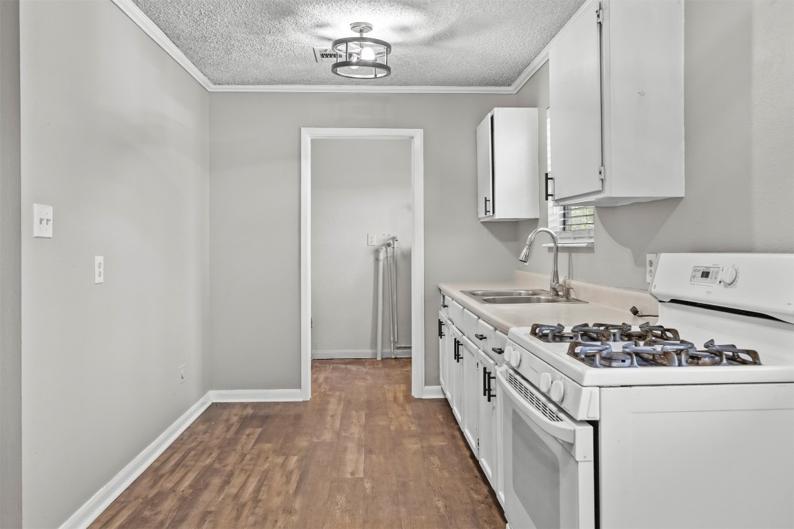 801 Campbell Acres Road Cleveland, TX 77328 - Photo 10 of 36 a kitchen with stainless steel appliances granite countertop a stove and a sink