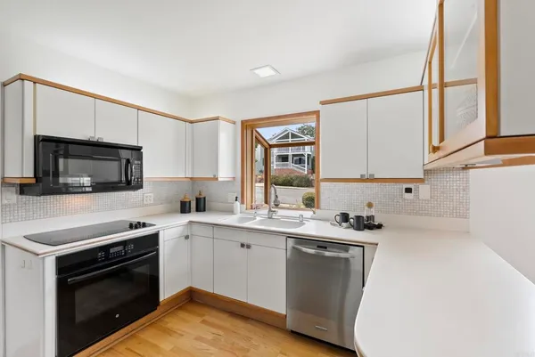 a kitchen with a sink stove and microwave