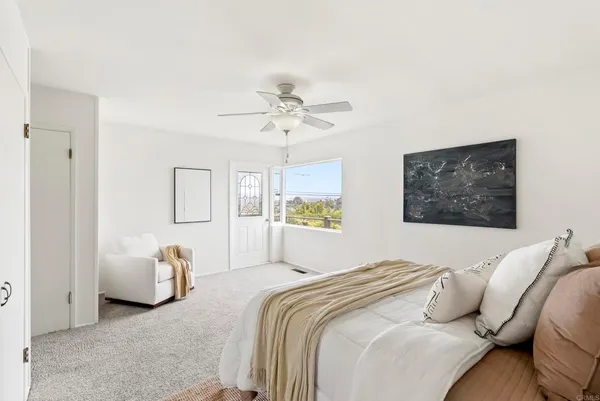 a bedroom with a bed and a couch