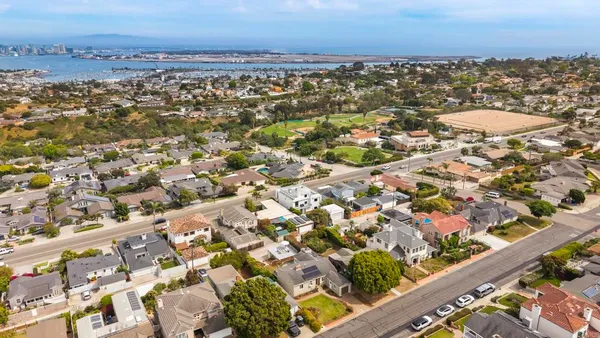 an aerial view of residential house with outdoor space and swimming pool