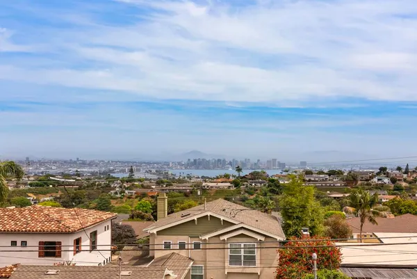 an aerial view of residential houses with city view