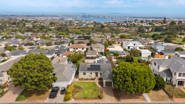 an aerial view of residential houses with outdoor space