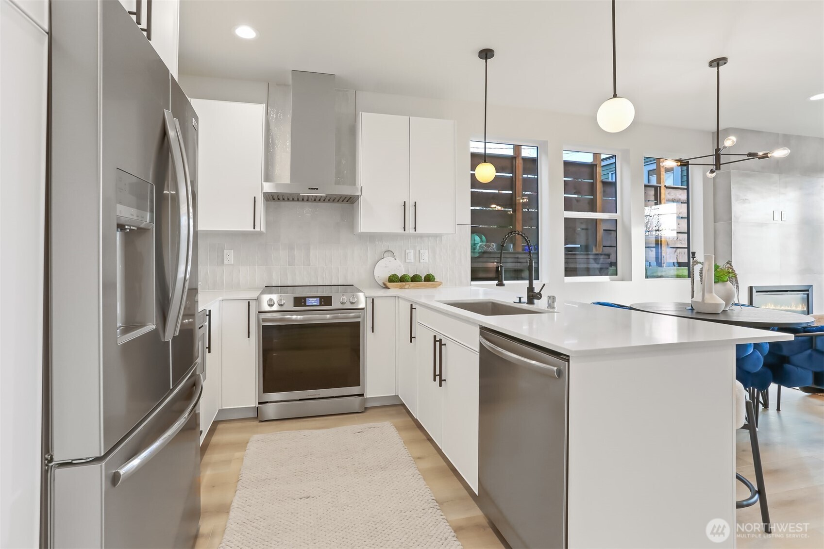 836 Northwest 50th Street Seattle, WA 98107 - Photo 13 of 35 a kitchen with stainless steel appliances granite countertop a refrigerator a sink and a stove