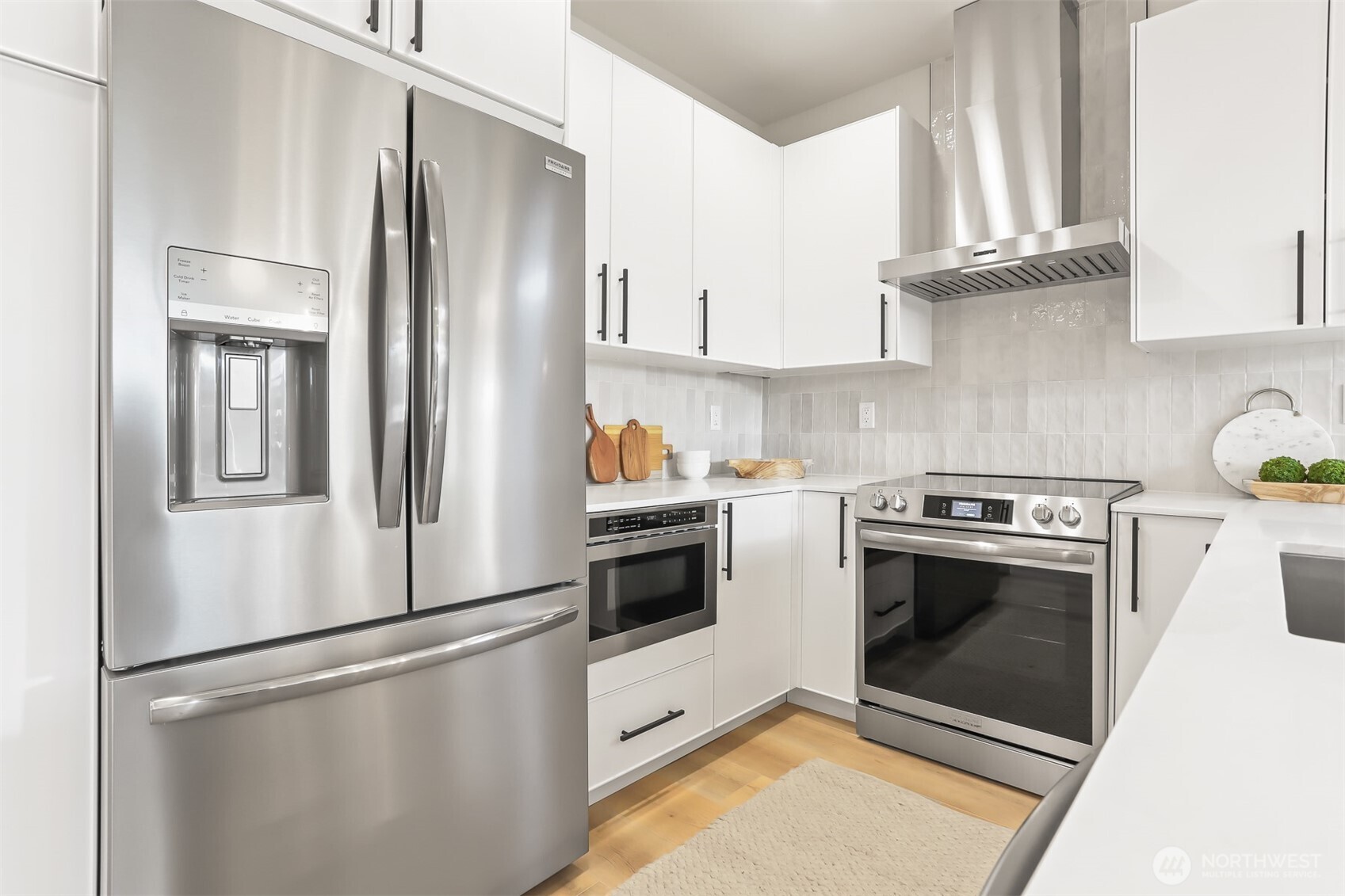 836 Northwest 50th Street Seattle, WA 98107 - Photo 14 of 35 a kitchen with stainless steel appliances granite countertop a refrigerator a stove and white cabinets