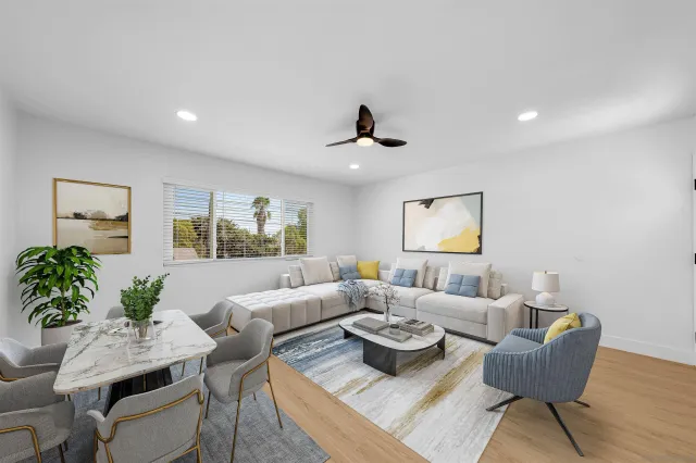 a living room with furniture and wooden floor