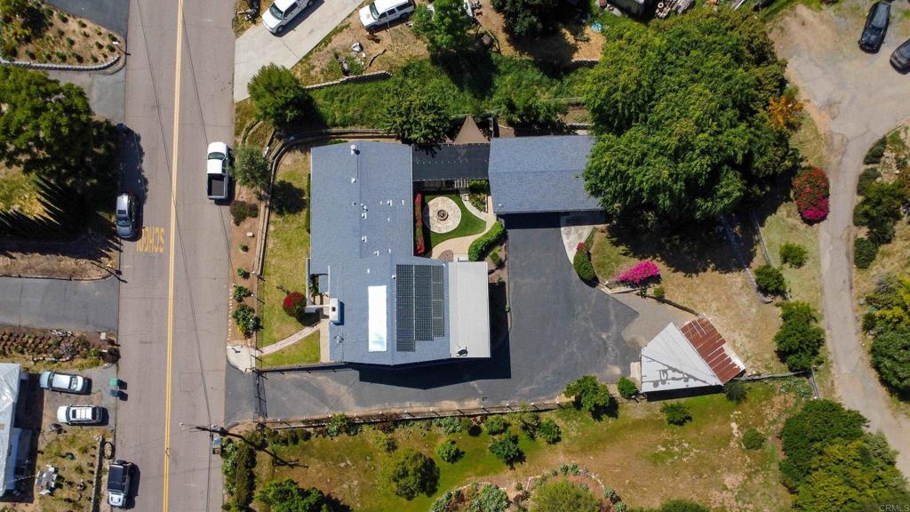 an aerial view of house with yard swimming pool and outdoor seating