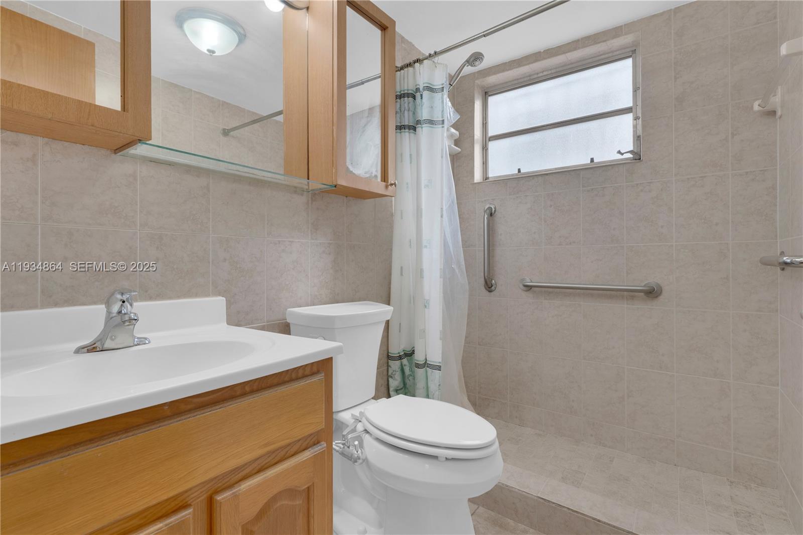 47 Northwest 47th Avenue, Unit 1 Miami, FL 33126 - Photo 11 of 14 a bathroom with a sink a toilet and shower