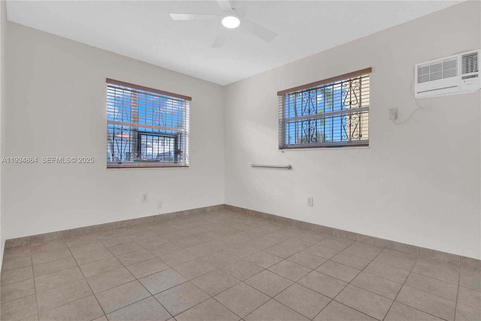 47 Northwest 47th Avenue, Unit 1 Miami, FL 33126 - Photo 12 of 14 an empty room with windows