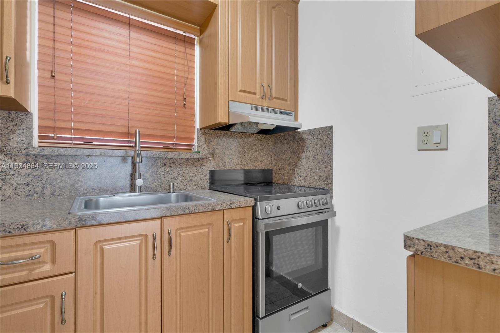 47 Northwest 47th Avenue, Unit 1 Miami, FL 33126 - Photo 6 of 14 a kitchen with stainless steel appliances granite countertop a sink and a white cabinets