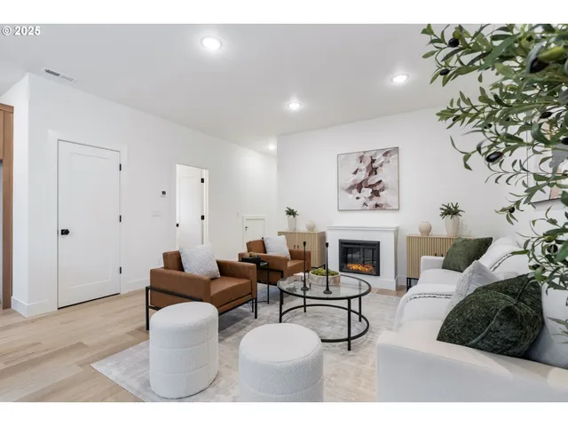 a living room with furniture a fireplace and a potted plant