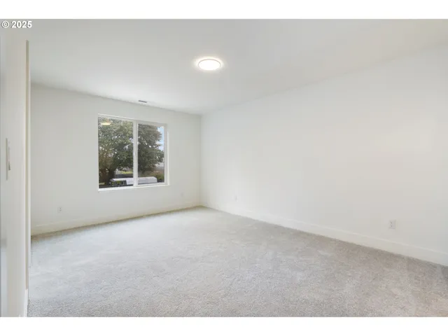 a view of an empty room with windows