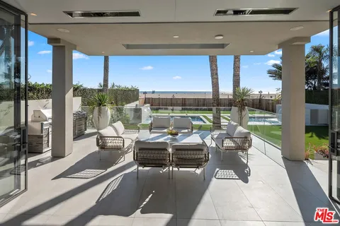 a view of a patio with couches chairs and potted plants