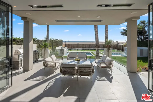 a view of a patio with couches chairs and potted plants