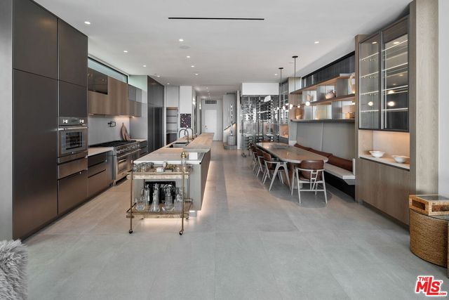 a kitchen with kitchen island cabinets and chairs in it