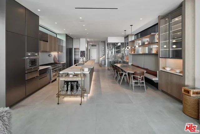 a kitchen with kitchen island cabinets and chairs in it