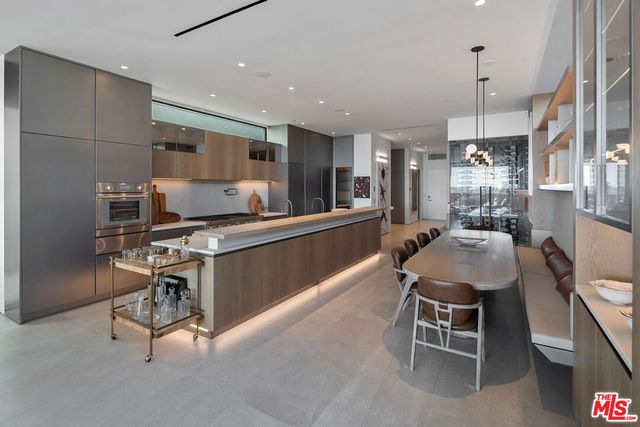 a large kitchen with stainless steel appliances lots of counter space and breakfast area