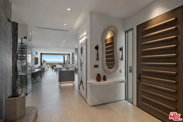 a view of living room and kitchen with stainless steel appliances