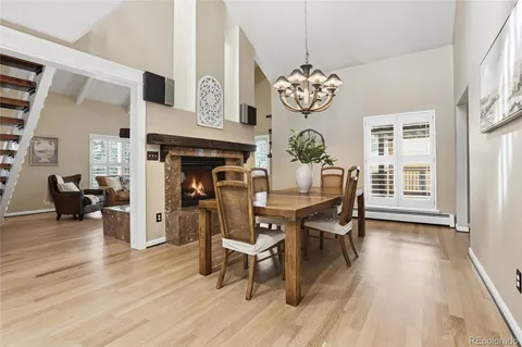 a dining room with furniture a fireplace and chandelier