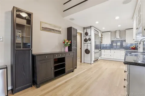 a kitchen with granite countertop stainless steel appliances a refrigerator and cabinets