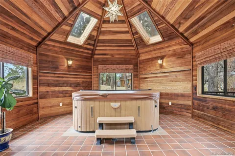 a roof deck with a dining table and chairs with wooden floor