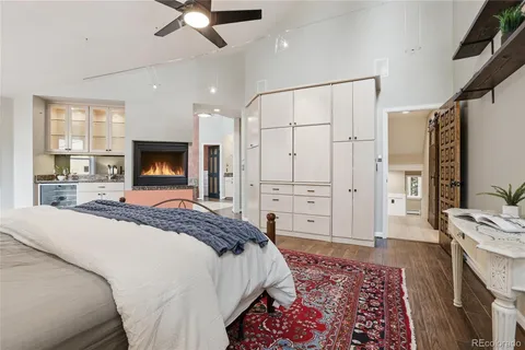 a spacious bathroom with a granite countertop sink a mirror and shower