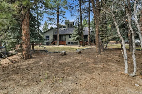 a view of a house with a yard and sitting area