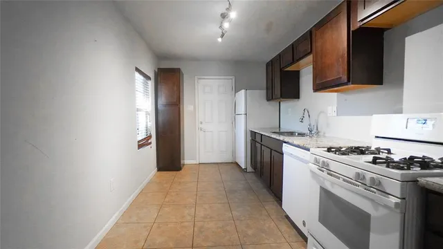 a kitchen with stainless steel appliances granite countertop a stove and a refrigerator