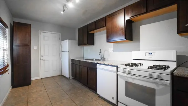a kitchen with a stove and a refrigerator