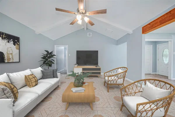 a living room with furniture and a flat screen tv