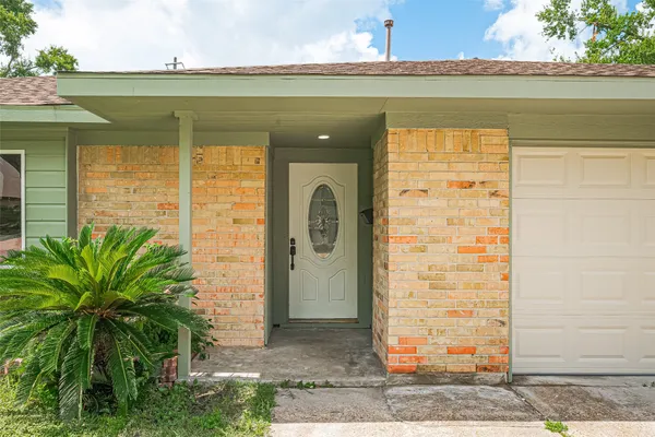 a front view of a house with plants