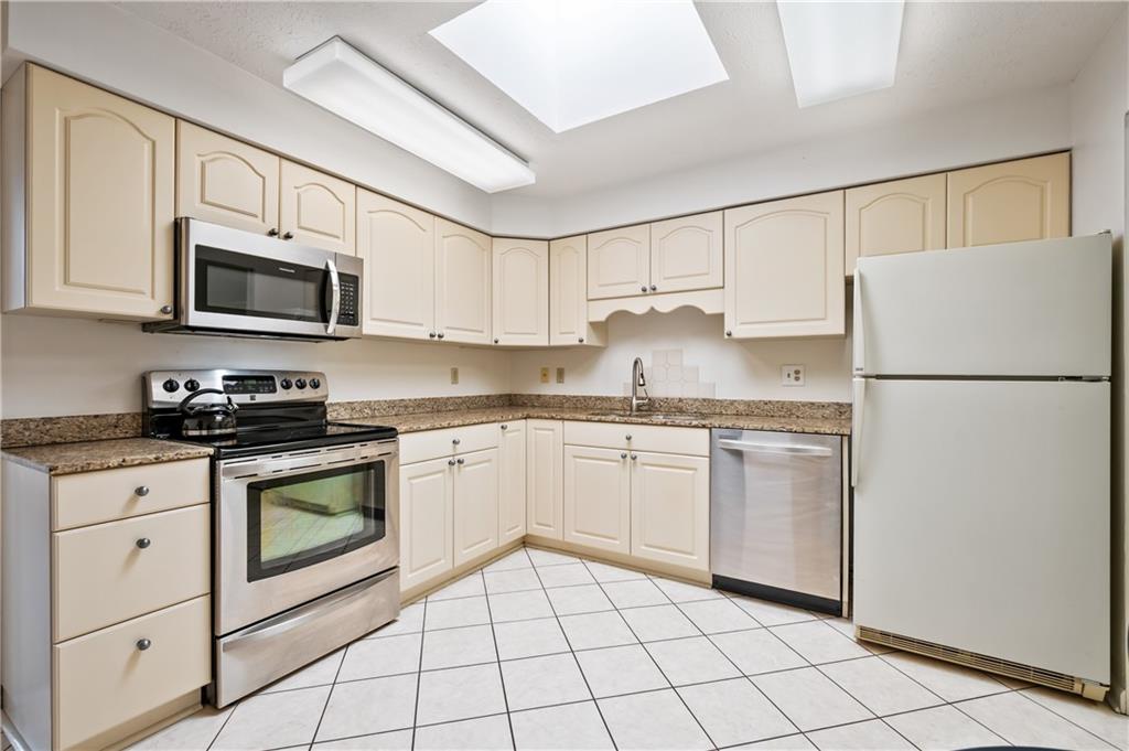 100 Denniston Street, Unit 304 Pittsburgh, PA 15206 - Photo 11 of 27 a kitchen with granite countertop cabinets stainless steel appliances and a counter space