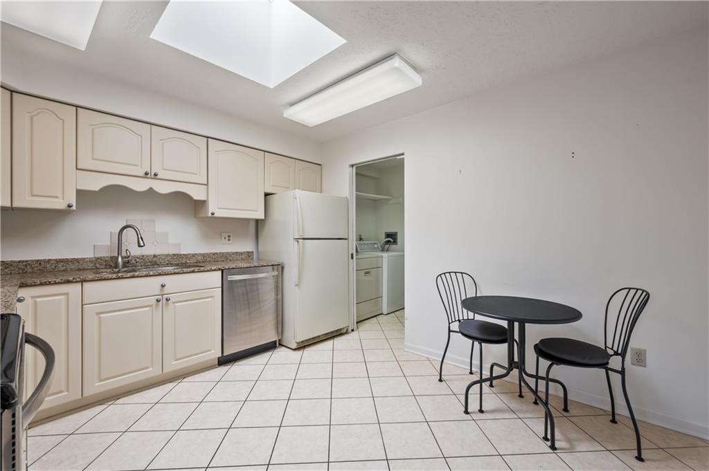 100 Denniston Street, Unit 304 Pittsburgh, PA 15206 - Photo 13 of 27 a kitchen with cabinets and chairs