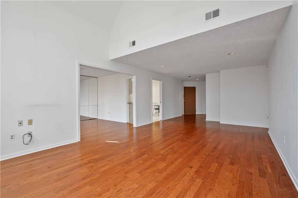 100 Denniston Street, Unit 304 Pittsburgh, PA 15206 - Photo 5 of 27 a view of an empty room with wooden floor and closet