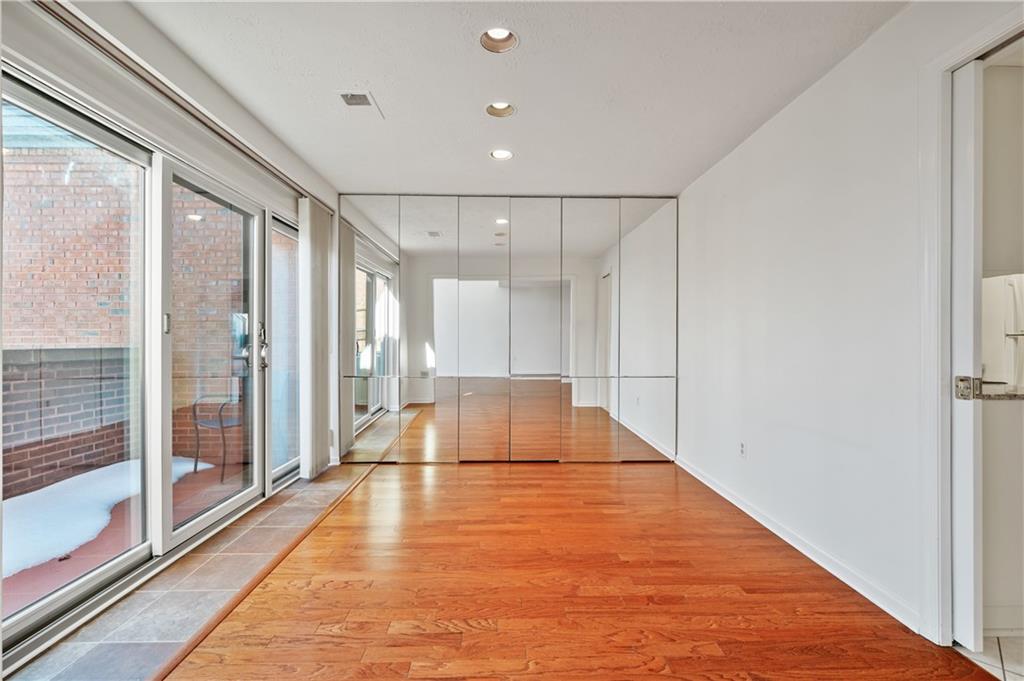 100 Denniston Street, Unit 304 Pittsburgh, PA 15206 - Photo 7 of 27 a hallway with wooden floor and glass door