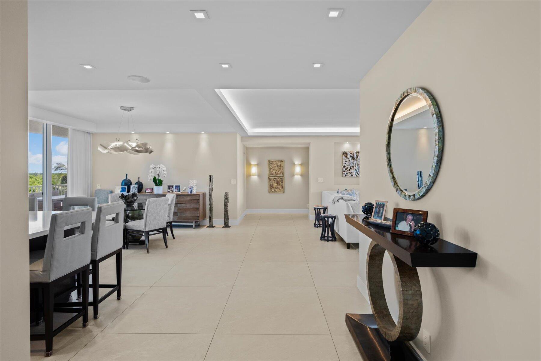 2500 South Ocean Boulevard, Unit 3A3 Palm Beach, FL 33480 - Photo 2 of 39 a living room with furniture a mirror a clock and a windows