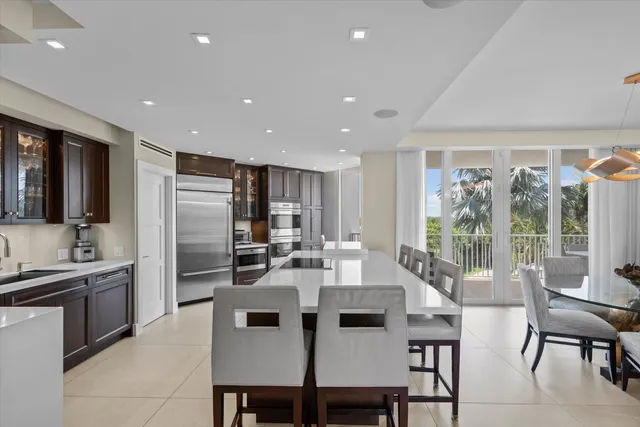 a large kitchen with stainless steel appliances a sink and a large counter space