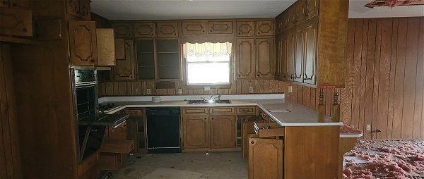1041 Southeast 5th Street Cooper, TX 75432 - Photo 2 of 4 a kitchen with a sink stove top oven and cabinets