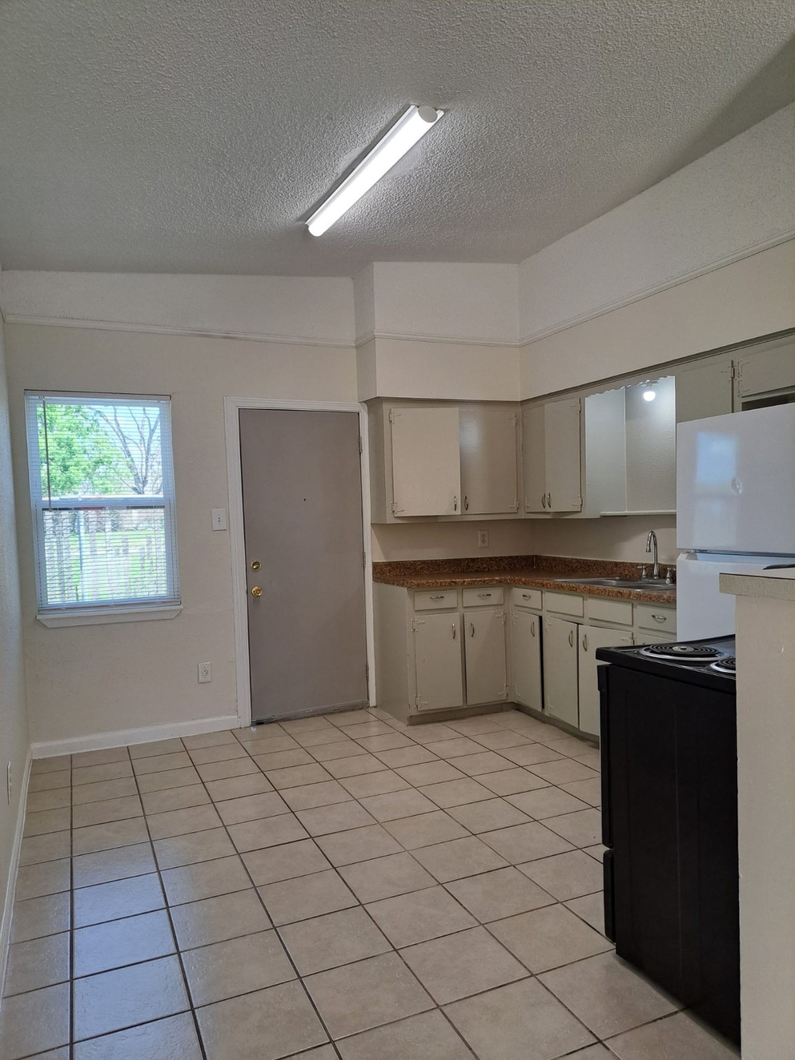 3357 Frick Road, Unit 3 Houston, TX 77086 - Photo 2 of 7 Light-filled and open space in the kitchen area, electric stove and refrigerator included.