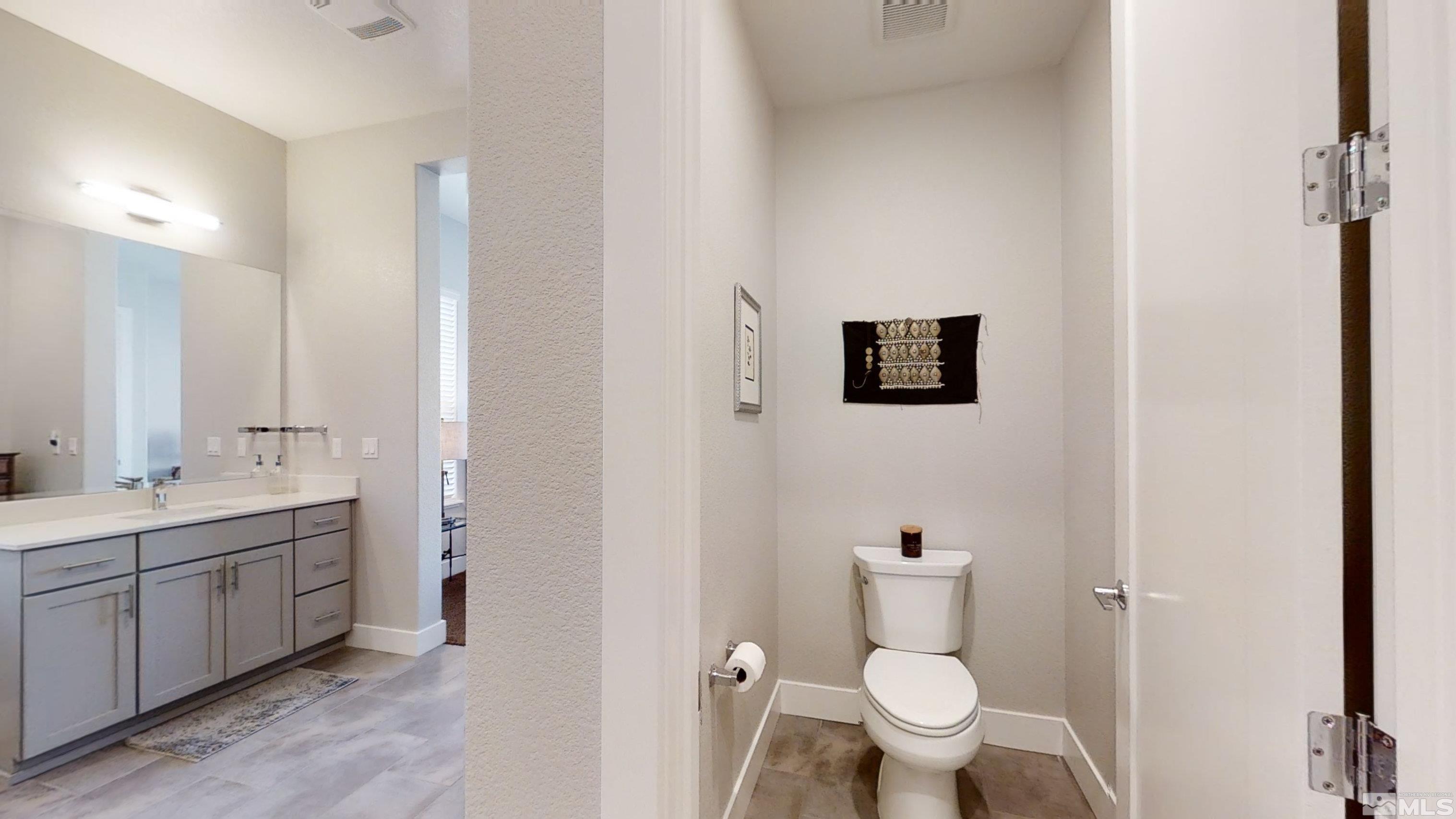 8779 Larkhaven Trail Reno, NV 89523 - Photo 19 of 32 a bathroom with a toilet sink and mirror
